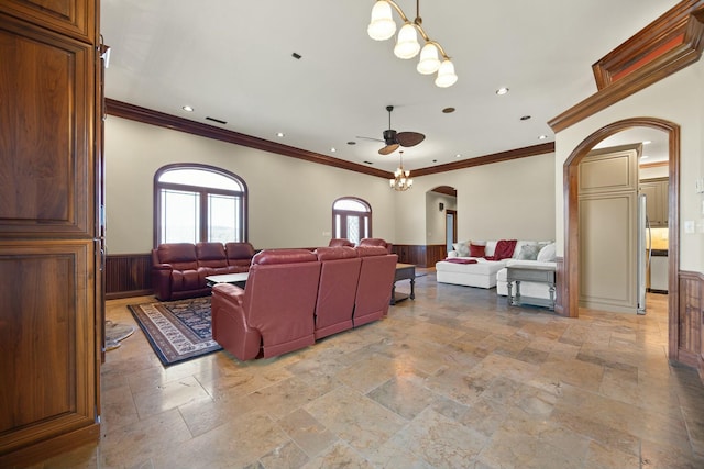 living room featuring a ceiling fan, a wainscoted wall, visible vents, recessed lighting, and arched walkways