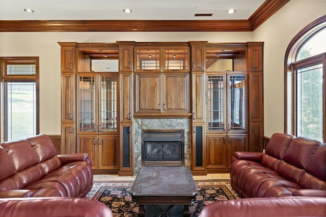 living room with recessed lighting, visible vents, a fireplace, and crown molding