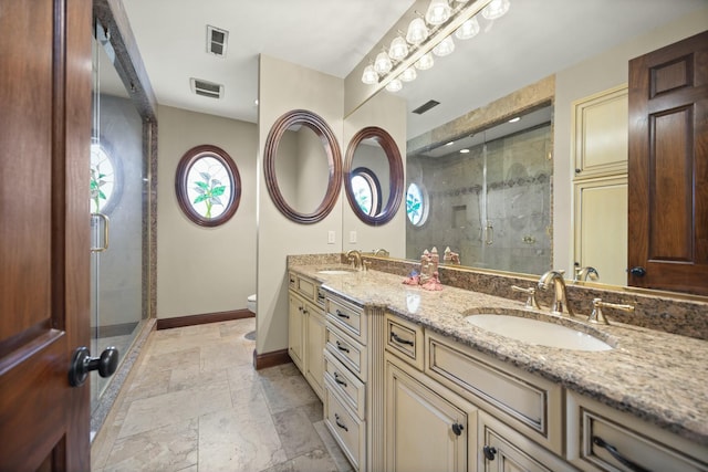 full bath with visible vents, a shower stall, baseboards, and a sink