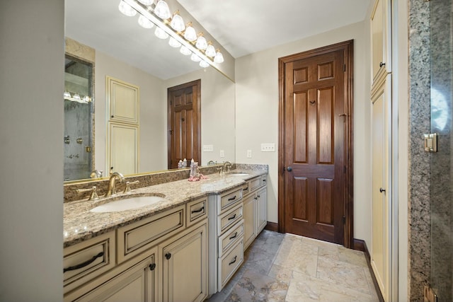 bathroom with a shower stall, double vanity, and a sink