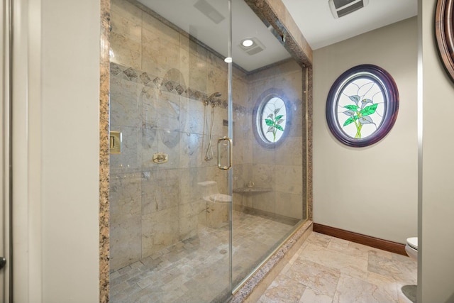 bathroom featuring visible vents, stone finish flooring, baseboards, toilet, and a stall shower