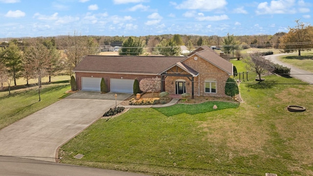 view of front of house featuring a front yard, fence, concrete driveway, a garage, and brick siding