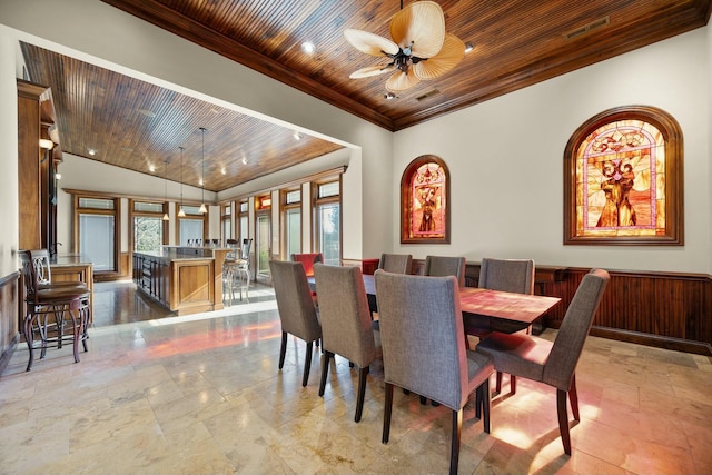 dining room with a healthy amount of sunlight, wood ceiling, crown molding, and ceiling fan