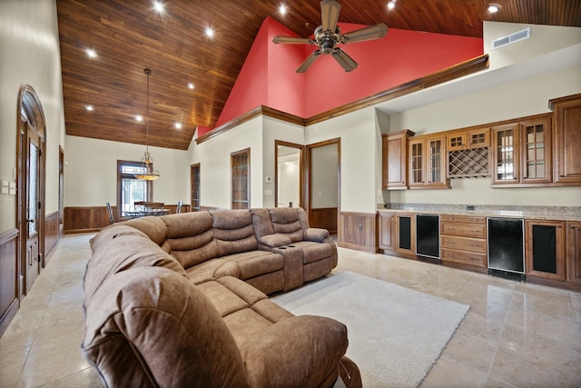 living room featuring wooden ceiling, high vaulted ceiling, visible vents, and wainscoting