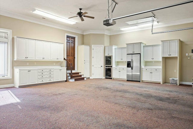 garage featuring baseboards, ceiling fan, wine cooler, a garage door opener, and stainless steel fridge