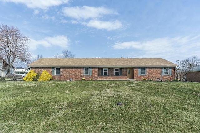 ranch-style house featuring brick siding and a front lawn