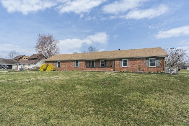 ranch-style house featuring brick siding and a front yard