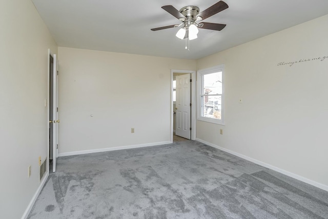 unfurnished room featuring ceiling fan, carpet, and baseboards