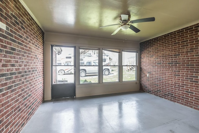 unfurnished sunroom with a ceiling fan