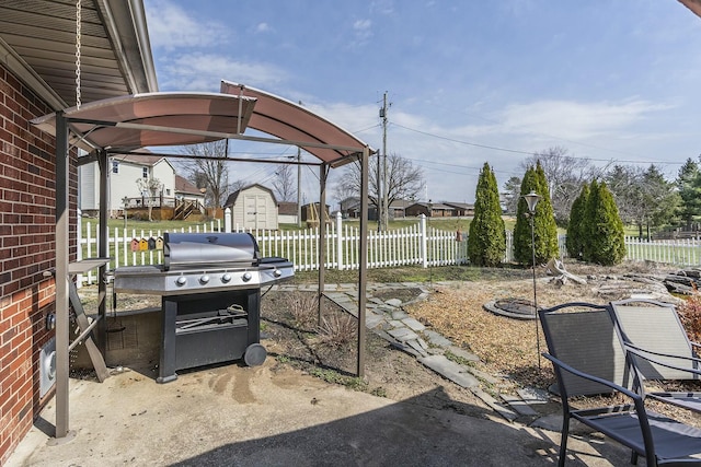 view of patio / terrace with grilling area and fence