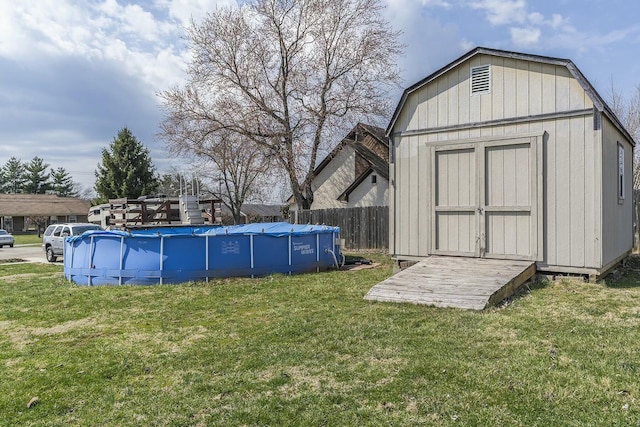 view of shed featuring a fenced in pool and fence