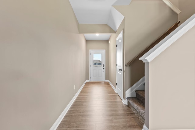 entryway featuring stairs, wood finished floors, and baseboards