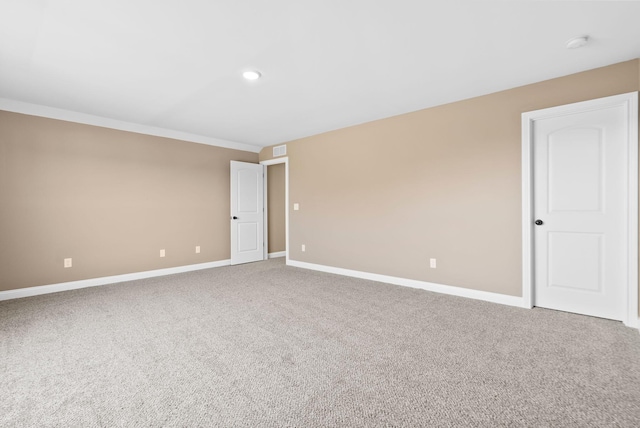 spare room featuring recessed lighting, baseboards, carpet floors, and visible vents