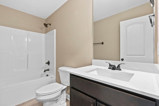 bathroom featuring toilet,  shower combination, wood finished floors, and vanity