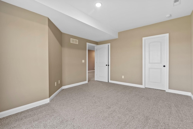 interior space featuring visible vents, carpet floors, and baseboards