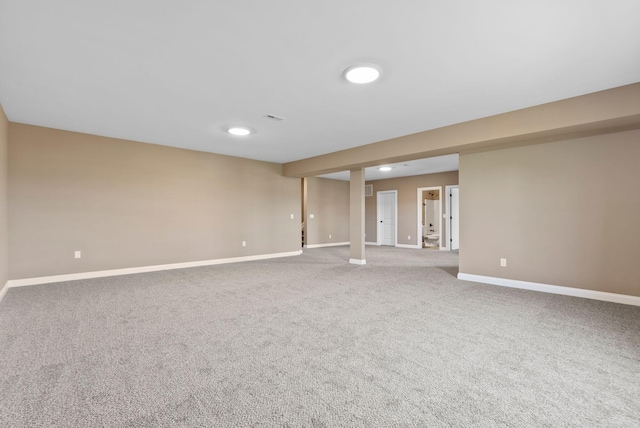 carpeted empty room featuring visible vents and baseboards