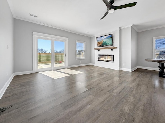 unfurnished living room featuring visible vents, crown molding, ceiling fan, and wood finished floors