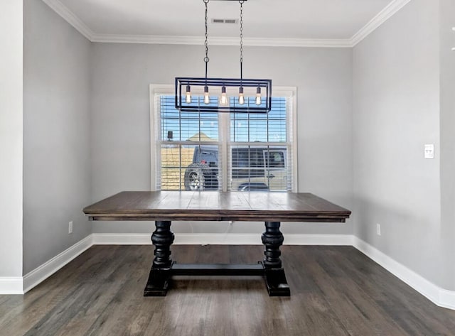 dining room with crown molding, wood finished floors, visible vents, and baseboards