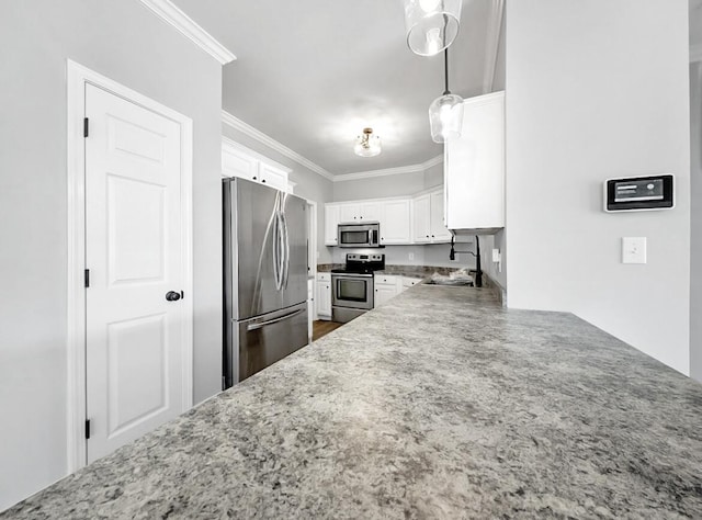 kitchen featuring ornamental molding, light stone counters, appliances with stainless steel finishes, white cabinets, and a sink