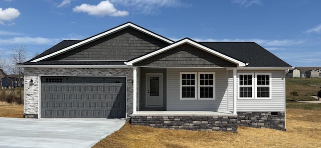 view of front of house with a porch, an attached garage, and concrete driveway