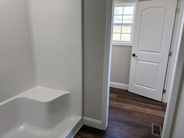 bathroom with visible vents, baseboards, and wood finished floors