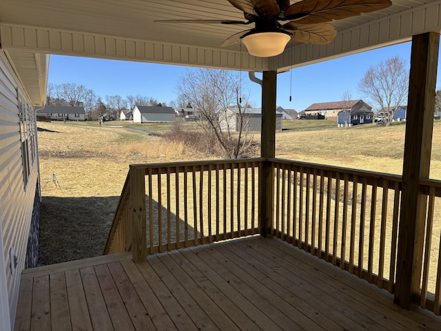 deck with a residential view and a ceiling fan