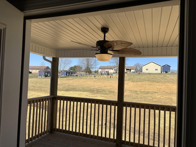 deck with a yard and a ceiling fan