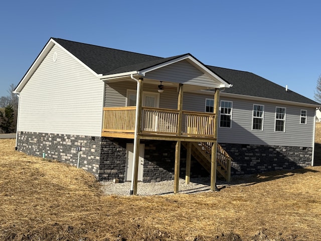 back of property featuring a wooden deck, a ceiling fan, roof with shingles, and stairs