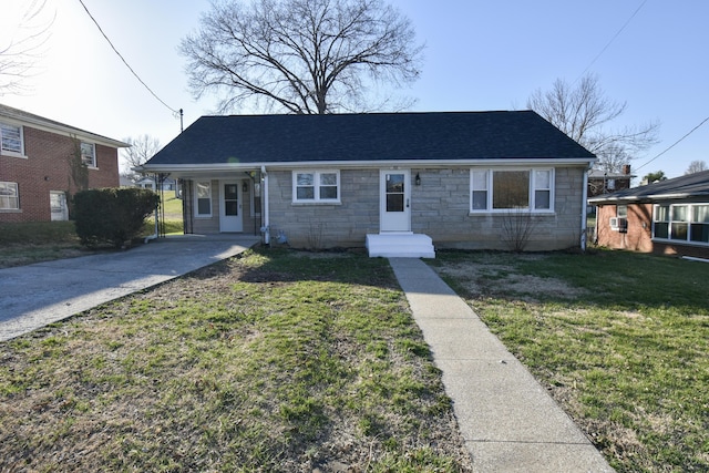 bungalow-style house with an attached carport, a shingled roof, a front lawn, concrete driveway, and stone siding