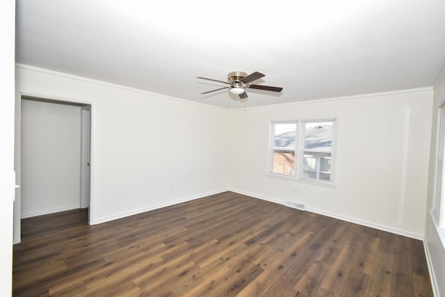 unfurnished room featuring visible vents, ornamental molding, a ceiling fan, dark wood-style floors, and baseboards