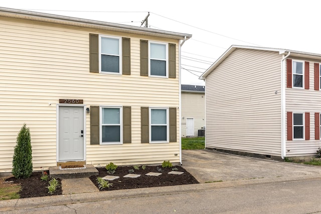 view of front of home with central air condition unit and driveway