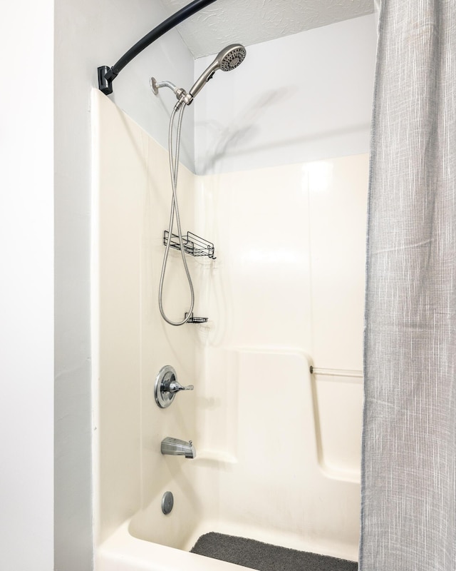 full bath featuring shower / tub combo with curtain