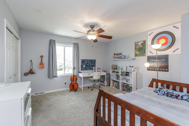 bedroom with visible vents, baseboards, light carpet, a closet, and a ceiling fan