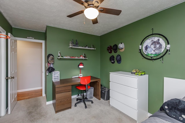 carpeted bedroom with baseboards, a textured ceiling, and a ceiling fan