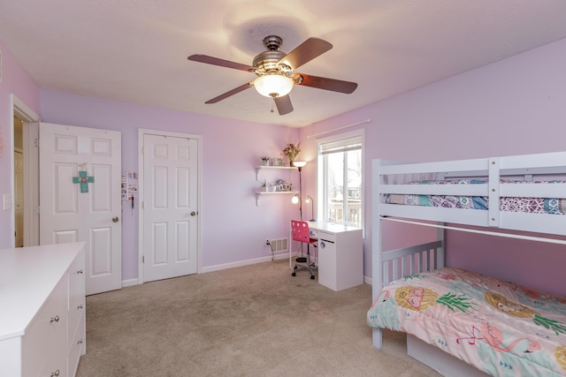 bedroom featuring light carpet, baseboards, and a ceiling fan