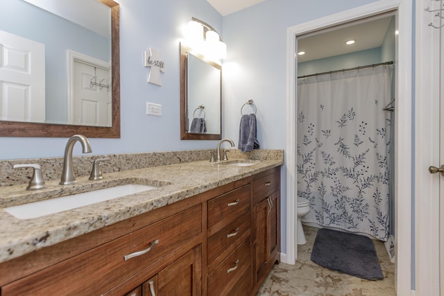 full bath featuring a sink, toilet, marble finish floor, and double vanity