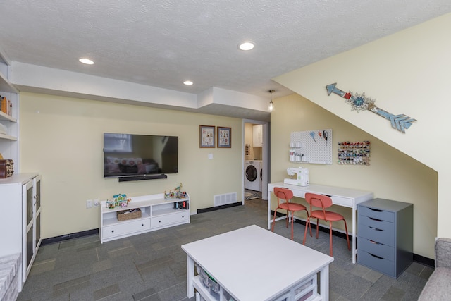 living area with recessed lighting, baseboards, and a textured ceiling