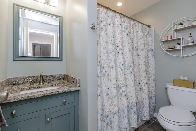 bathroom featuring a shower with shower curtain, toilet, vanity, and tile patterned flooring