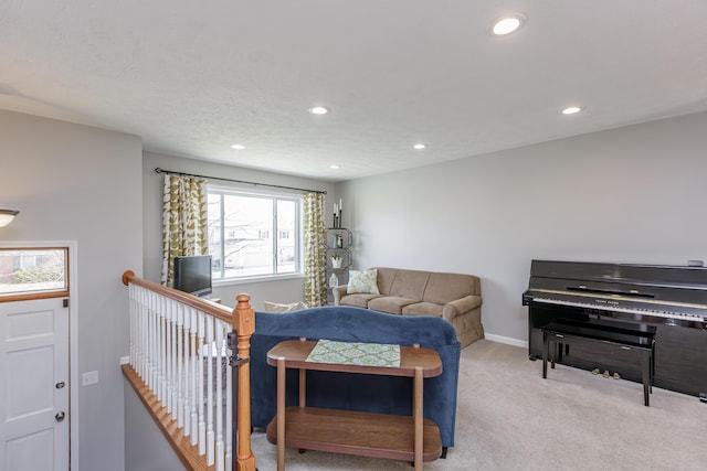 carpeted living room with recessed lighting, baseboards, and a textured ceiling