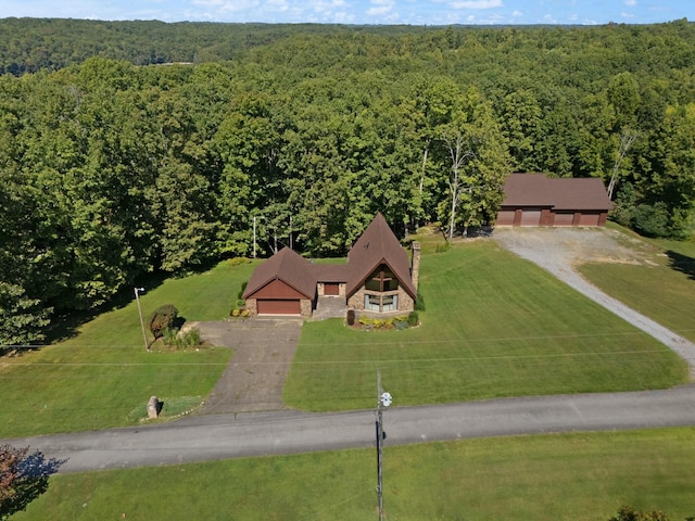 birds eye view of property with a forest view