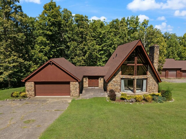 a-frame style home with a front lawn, aphalt driveway, stone siding, a garage, and a chimney