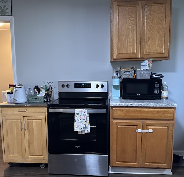 kitchen featuring stainless steel range with electric stovetop, wood finished floors, and black microwave