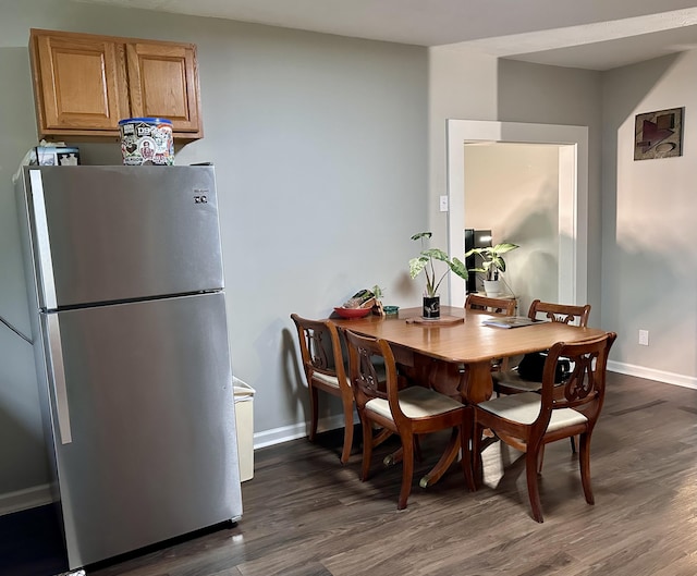 dining area with baseboards and dark wood-style flooring