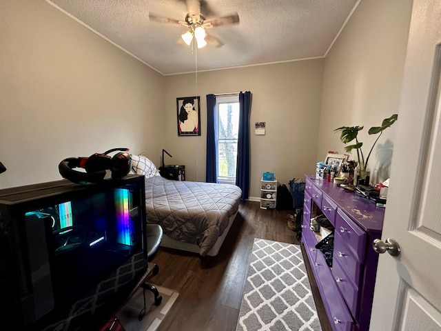 bedroom featuring ceiling fan, ornamental molding, wood finished floors, and a textured ceiling