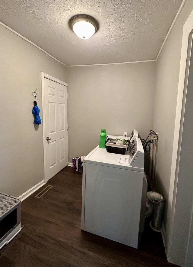 laundry room with baseboards, visible vents, laundry area, dark wood-type flooring, and a textured ceiling