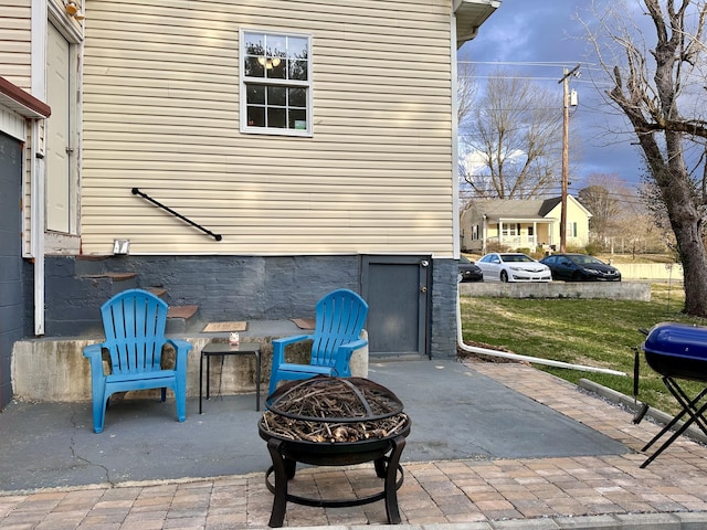 view of patio / terrace with a fire pit and a grill