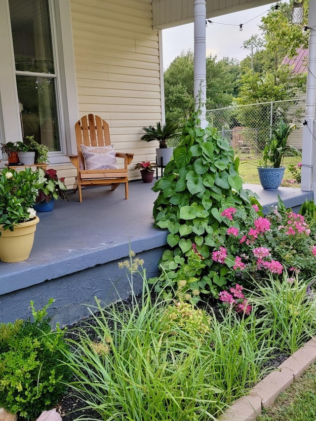 view of patio / terrace with a porch and fence