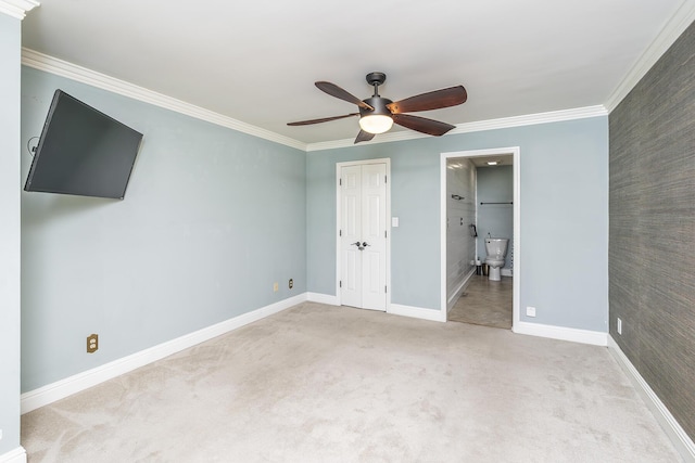 unfurnished bedroom featuring carpet, baseboards, and ornamental molding