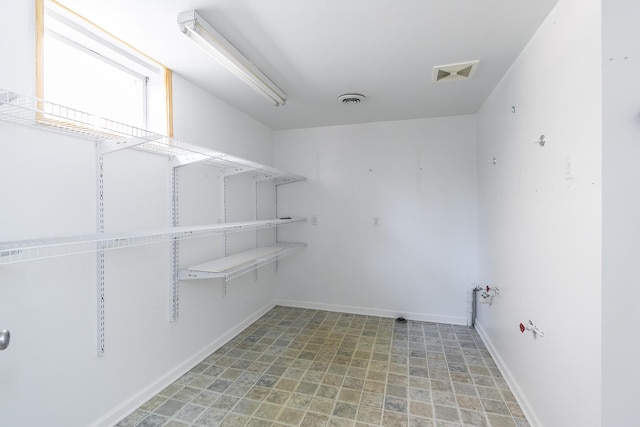 laundry room with visible vents and baseboards