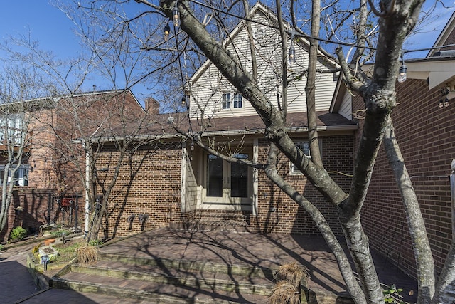 view of property exterior featuring brick siding